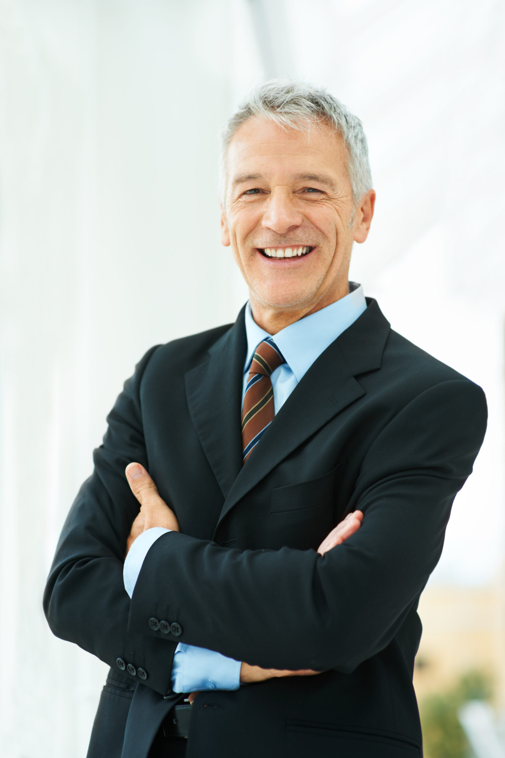 Leading his company forward. Shot of a mature business standing in an office building hallway